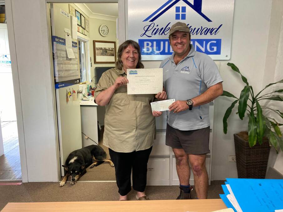 GIVING: Ann Fuller from OnTrack Hunter and Link Upward, Link Upward Building, Singleton with his $5000 donation to the local charity. Photo supplied.