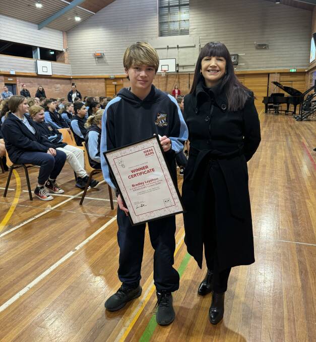 Year 7 student Bradley Leyshon with Singleton High School's principal Liana Gill at the assembly where he received an award from MED-EL. 