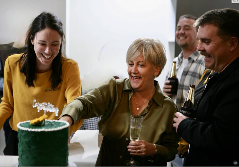 Sue Shaddock cuts the farewell cake with Danielle Carey while Sue's sons Charles and Callum enjoy the celebrations. Picture supplied