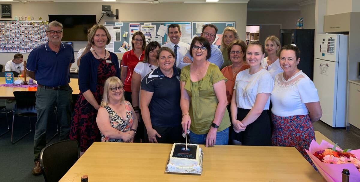 Sharon Yardley (cutting the cake) with her work colleagues at the launch of her book 'Don't be Afraid of the Dark' at St Catherine's Catholic College. Photo supplied.