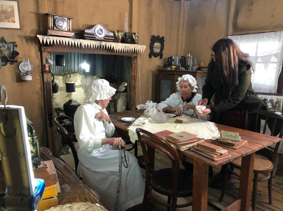 Suzannah Jones from AUH pouring tea for Carmel and Gwen inside the Pioneer Cottage for Murrurundi & District Historical Societys Twins At Pioneer Cottage project funded by CASP 2023. Picture by Jenny Loasby