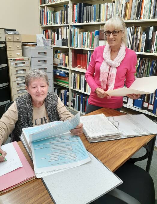 HISTORY: Local residents Karen Malmgren and Trish Paterson looking at records in the Family History Society Singleton Inc Library.
