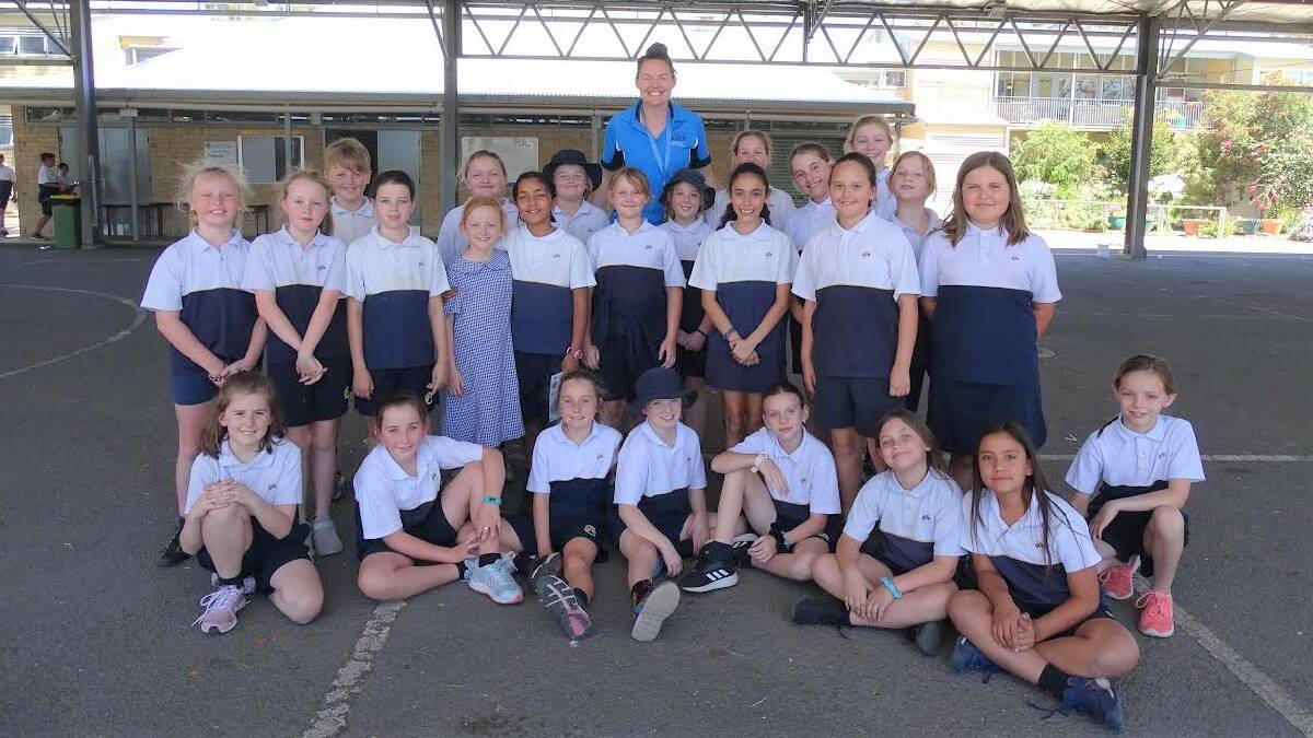 NEXT GENERATION: Suncorp Super Netball star Sam Poolman (Giants) pictured with her fans during a clinic at Singleton Public School this week.